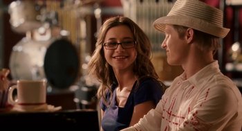 Movie still from “High School Musical 3: Senior Year” (2008), directed by Kenny Ortega – A man and a woman smiling for the camera; Close Up shot, Over the shoulder angle