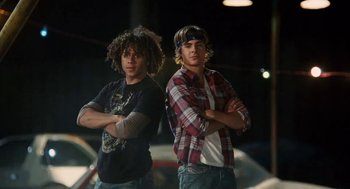 Movie still from “High School Musical 3: Senior Year” (2008), directed by Kenny Ortega – A couple of men standing next to each other; Medium shot, Low angle