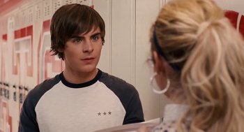 Movie still from “High School Musical 3: Senior Year” (2008), directed by Kenny Ortega – A man and a woman looking at each other in front of a mirror; Medium shot, Over the shoulder angle