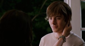 Movie still from “High School Musical 3: Senior Year” (2008), directed by Kenny Ortega – A young man is looking at a woman's wrist; Close Up shot, Over the shoulder angle