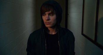 Movie still from “High School Musical 3: Senior Year” (2008), directed by Kenny Ortega – A young man wearing a black jacket and a black hoodie; Close Up shot, Low angle