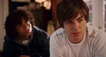 Movie still from “High School Musical 3: Senior Year” (2008), directed by Kenny Ortega – Two young men sitting next to each other in a room; Close Up shot, Over the shoulder angle
