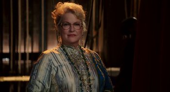 Movie still from “High School Musical 3: Senior Year” (2008), directed by Kenny Ortega – An older woman wearing glasses and a long necklace; Close Up shot, Low angle