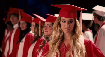 Movie still from “High School Musical 3: Senior Year” (2008), directed by Kenny Ortega – A group of women in graduation caps and gowns; Close Up shot, Low angle