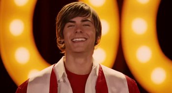 Movie still from “High School Musical 3: Senior Year” (2008), directed by Kenny Ortega – A person smiling; Close Up shot, Low angle