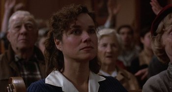 Movie still from “Hoosiers” (1986), directed by David Anspaugh – A woman is looking up at something in the air; Close Up shot, Low angle