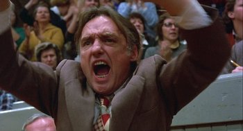 Movie still from “Hoosiers” (1986), directed by David Anspaugh – A man in a crowd of people with his mouth wide open; Close Up shot, Low angle
