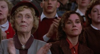 Movie still from “Hoosiers” (1986), directed by David Anspaugh – Two women in a crowd of people watching a game; Close Up shot, Low angle