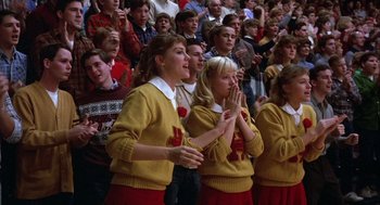 Movie still from “Hoosiers” (1986), directed by David Anspaugh – A group of young people standing in front of an audience; Medium shot, Low angle