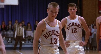 Movie still from “Hoosiers” (1986), directed by David Anspaugh – Two young men are playing basketball on a court; Medium shot, Low angle