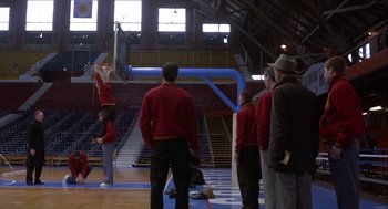 Movie still from “Hoosiers” (1986), directed by David Anspaugh – A group of people standing in a gymnasium; Wide shot, Low angle