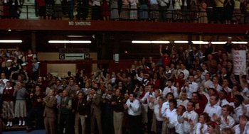Movie still from “Hoosiers” (1986), directed by David Anspaugh – A large group of people are gathered in a stadium; Extreme Wide shot, High angle