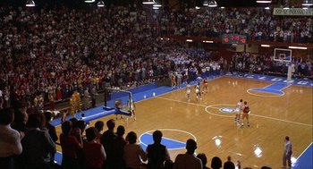 Movie still from “Hoosiers” (1986), directed by David Anspaugh – A crowd of people watching a basketball game; Extreme Wide shot, High angle