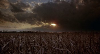 Movie still from “Hoosiers” (1986), directed by David Anspaugh – The sun is setting over a field of corn; Extreme Wide shot, Low angle