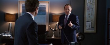 Movie still from “Horrible Bosses” (2011), directed by Seth Gordon – A man in a suit talking to a man in a tie; Medium shot, Over the shoulder angle