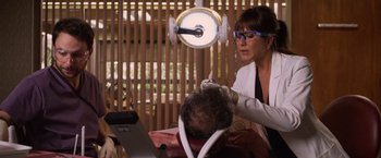 Movie still from “Horrible Bosses” (2011), directed by Seth Gordon – A woman in a white jacket is sitting in front of a computer; Close Up shot, Over the shoulder angle