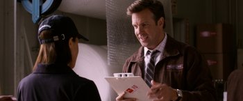 Movie still from “Horrible Bosses” (2011), directed by Seth Gordon – A man in a brown jacket holding a piece of paper; Close Up shot, Over the shoulder angle