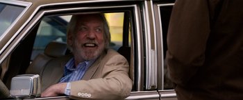 Movie still from “Horrible Bosses” (2011), directed by Seth Gordon – An older man sitting in the passenger seat of a car; Close Up shot, Low angle