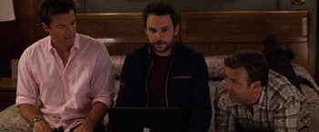 Movie still from “Horrible Bosses” (2011), directed by Seth Gordon – A man sitting in front of a laptop computer; Medium shot, High angle