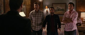 Movie still from “Horrible Bosses” (2011), directed by Seth Gordon – Two men standing next to each other in a living room; Medium shot, Over the shoulder angle