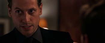 Movie still from “Horrible Bosses” (2011), directed by Seth Gordon – A person wearing a suit and tie; Close Up shot, Over the shoulder angle
