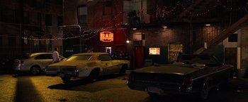 Movie still from “Horrible Bosses” (2011), directed by Seth Gordon – A group of cars parked in front of a bar; Extreme Wide shot, High angle