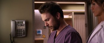 Movie still from “Horrible Bosses” (2011), directed by Seth Gordon – A man in a purple shirt is looking down at his face; Close Up shot, Over the shoulder angle
