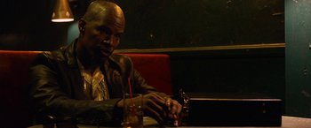 Movie still from “Horrible Bosses” (2011), directed by Seth Gordon – A man sitting at a table with a glass of soda; Close Up shot, High angle