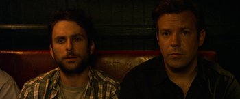 Movie still from “Horrible Bosses” (2011), directed by Seth Gordon – Two men sitting next to each other on a couch; Close Up shot, Overhead angle