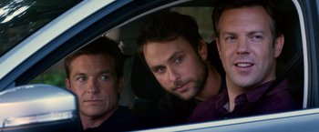 Movie still from “Horrible Bosses” (2011), directed by Seth Gordon – A group of men sitting in the back seat of a car; Close Up shot, Over the shoulder angle