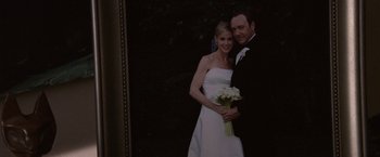 Movie still from “Horrible Bosses” (2011), directed by Seth Gordon – A man and a woman in wedding attire holding a bouquet of flowers; Close Up shot, Overhead angle