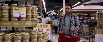 Movie still from “Horrible Bosses” (2011), directed by Seth Gordon – A man holding a red shopping cart in a store; Medium shot, Over the shoulder angle
