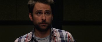 Movie still from “Horrible Bosses” (2011), directed by Seth Gordon – A person wearing a plaid shirt; Close Up shot, Over the shoulder angle
