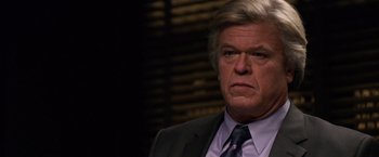 Movie still from “Horrible Bosses” (2011), directed by Seth Gordon – An older man in a suit and tie looking angry; Close Up shot, Over the shoulder angle