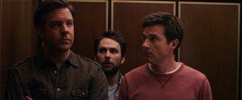 Movie still from “Horrible Bosses” (2011), directed by Seth Gordon – A group of men standing next to each other in a room; Close Up shot, Over the shoulder angle
