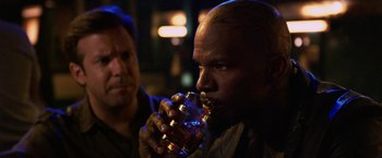 Movie still from “Horrible Bosses” (2011), directed by Seth Gordon – A man drinking a glass of alcohol in a dark room; Close Up shot, Over the shoulder angle