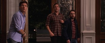 Movie still from “Horrible Bosses” (2011), directed by Seth Gordon – Two men standing next to each other on the sidewalk; Medium shot, Over the shoulder angle