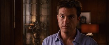 Movie still from “Horrible Bosses” (2011), directed by Seth Gordon – A person wearing a blue shirt; Close Up shot, Over the shoulder angle