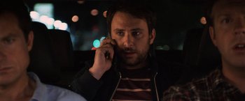 Movie still from “Horrible Bosses” (2011), directed by Seth Gordon – A man talking on a cell phone while sitting in a car; Close Up shot, Over the shoulder angle