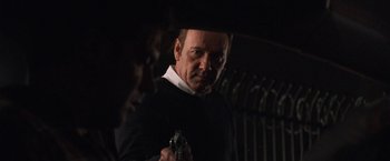 Movie still from “Horrible Bosses” (2011), directed by Seth Gordon – A man holding a handgun while standing next to another man; Close Up shot, Over the shoulder angle