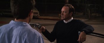 Movie still from “Horrible Bosses” (2011), directed by Seth Gordon – A man holding a gun pointed at another man; Close Up shot, Over the shoulder angle