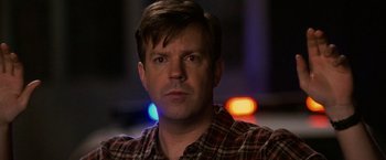 Movie still from “Horrible Bosses” (2011), directed by Seth Gordon – A person wearing a plaid shirt; Close Up shot, Low angle