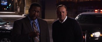 Movie still from “Horrible Bosses” (2011), directed by Seth Gordon – Two men standing next to each other in front of a building; Close Up shot, Over the shoulder angle