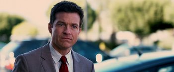 Movie still from “Horrible Bosses” (2011), directed by Seth Gordon – A person wearing a suit and tie; Close Up shot, Over the shoulder angle