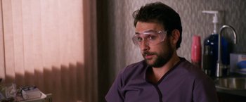Movie still from “Horrible Bosses” (2011), directed by Seth Gordon – A man wearing safety glasses and a purple shirt; Close Up shot, Over the shoulder angle