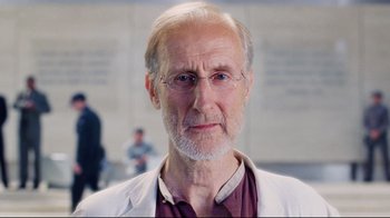 Movie still from “I, Robot” (2004), directed by Alex Proyas – An older man wearing glasses and a lab coat; Close Up shot, Low angle