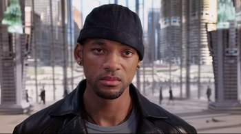 Movie still from “I, Robot” (2004), directed by Alex Proyas – A person wearing a jacket and a hat; Close Up shot, High angle