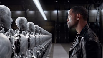 Movie still from “I, Robot” (2004), directed by Alex Proyas – A man in a black leather jacket looking at a row of mannequins in front of him; Close Up shot, Over the shoulder angle