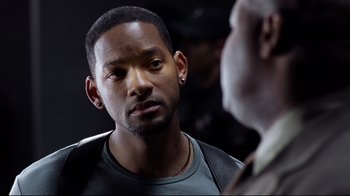 Movie still from “I, Robot” (2004), directed by Alex Proyas – A man in a leather jacket talking to another man in a leather jacket; Close Up shot, Over the shoulder angle