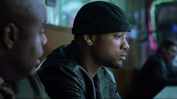 Movie still from “I, Robot” (2004), directed by Alex Proyas – A person wearing a hat; Close Up shot, Over the shoulder angle